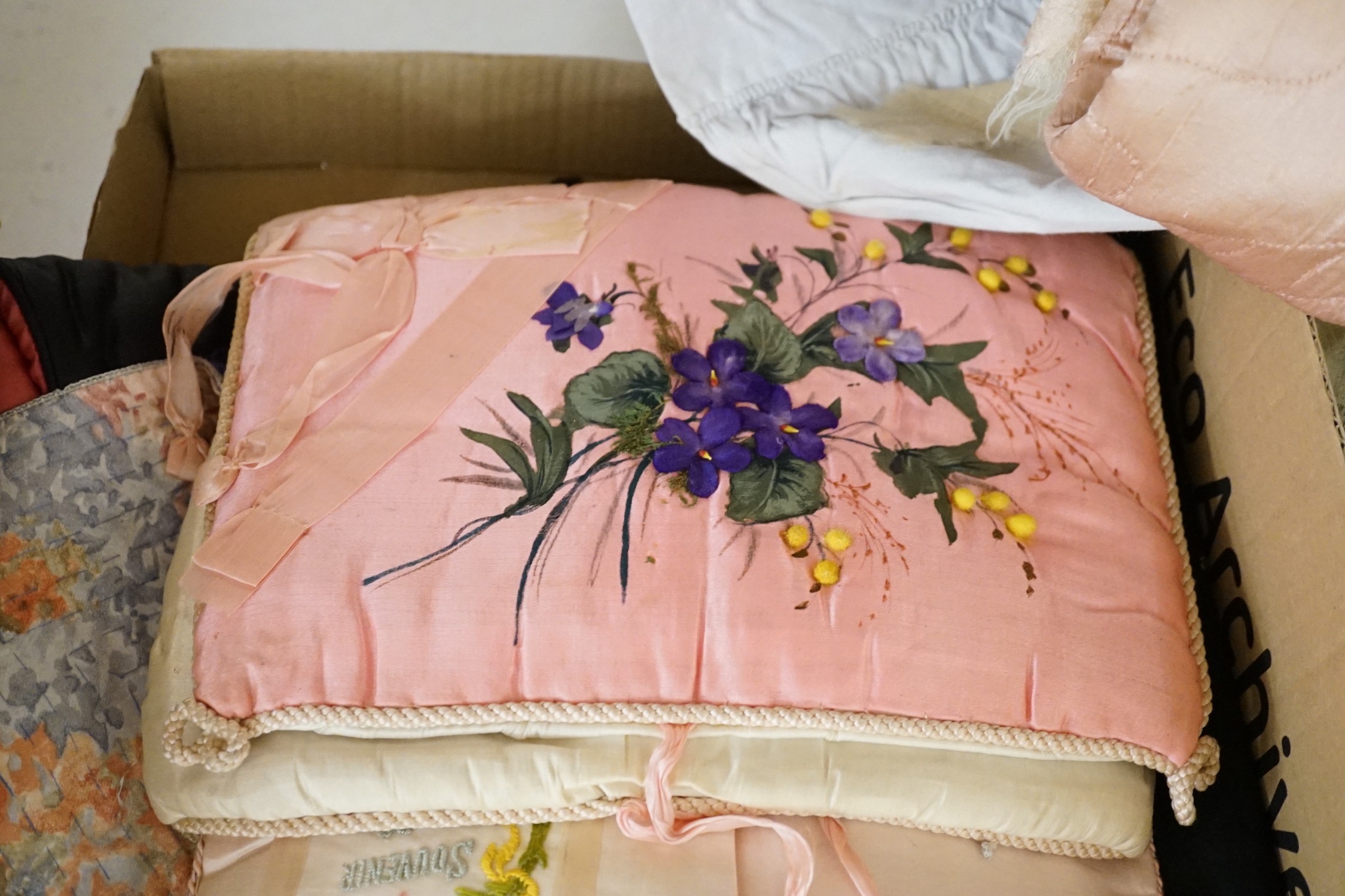A large collection of mixed European textiles including ribbon worked pyjama cases, Indian painted textiles, a sample book of braidings etc